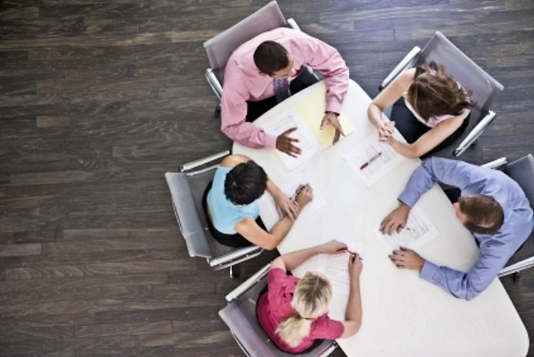 Aerial view of five people sitting around a table