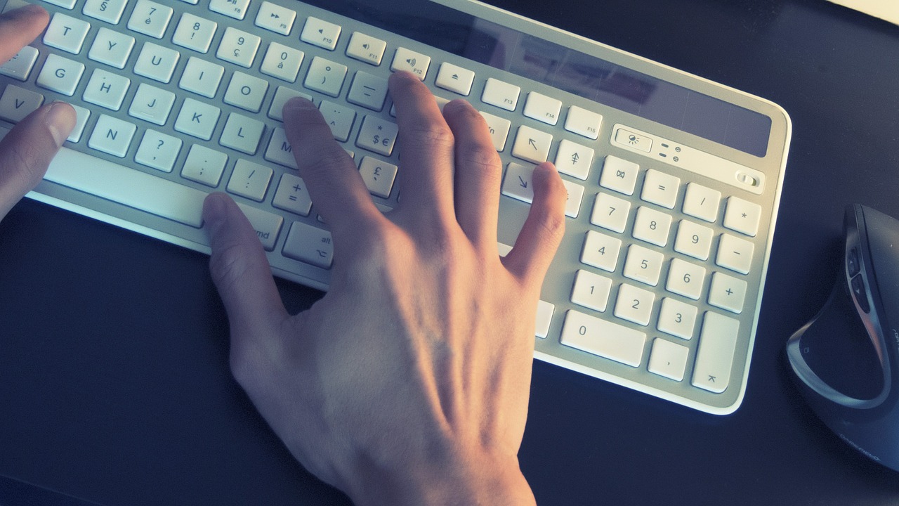 Hand typing on keyboard